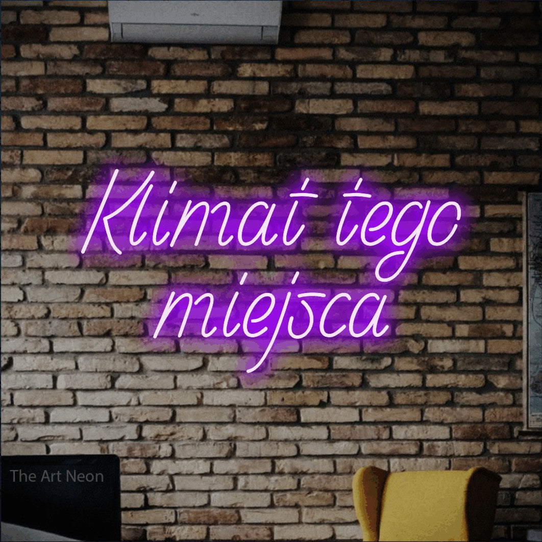 LED neon sign reading “Klimat tego miejsca”, arranged in two lines.