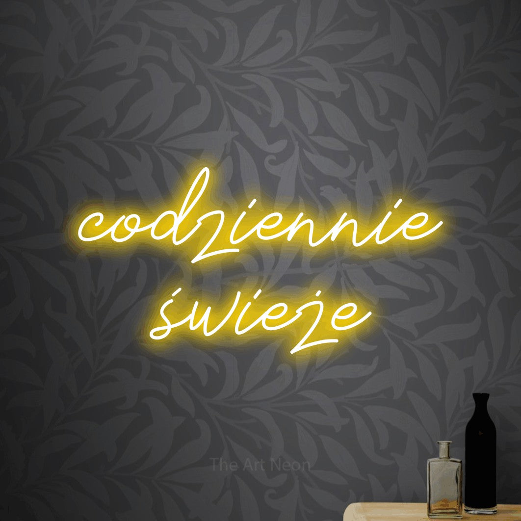 LED neon sign reading “codziennie świeże”, arranged in two lines.