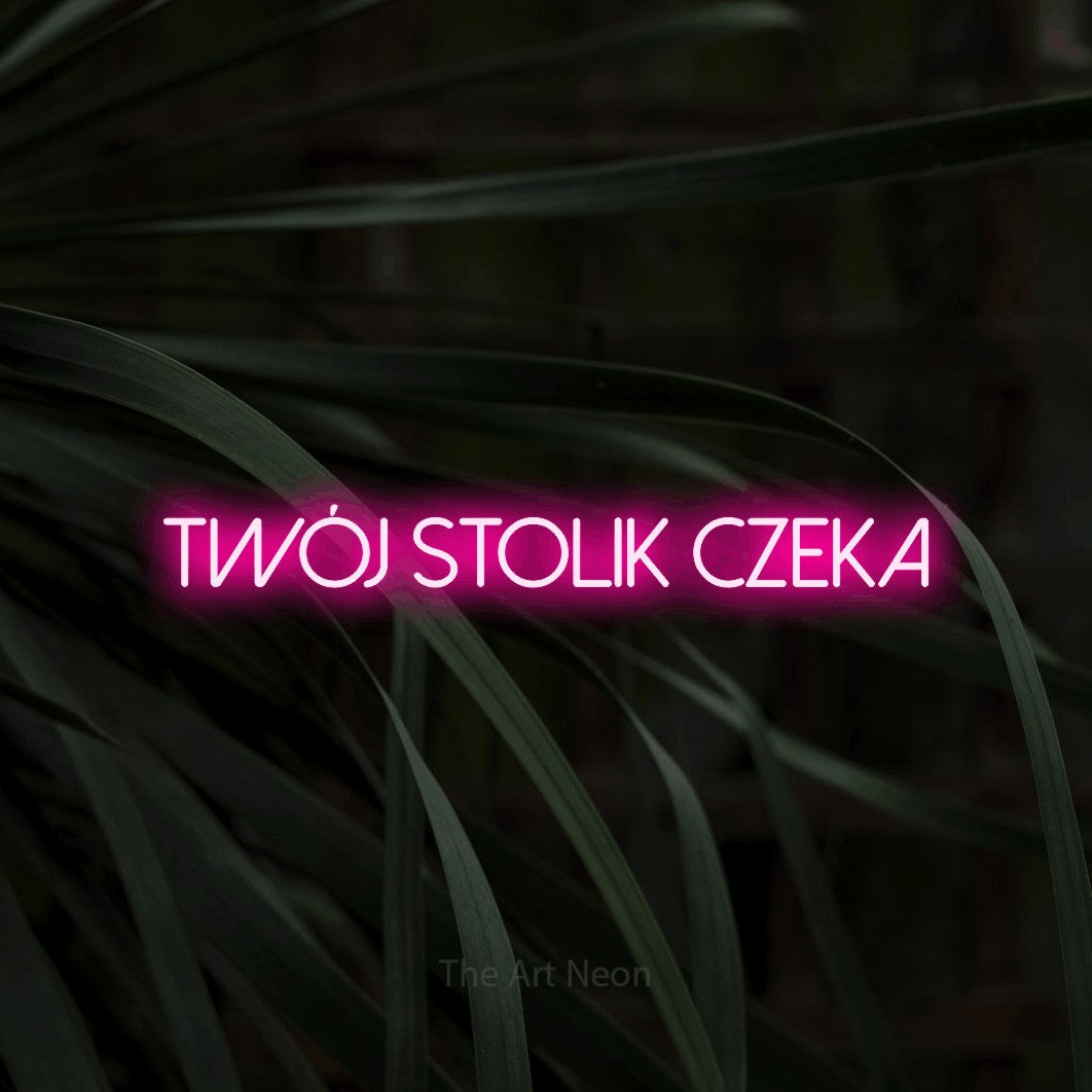LED neon sign reading “Twój stolik czeka”, arranged in a single line.