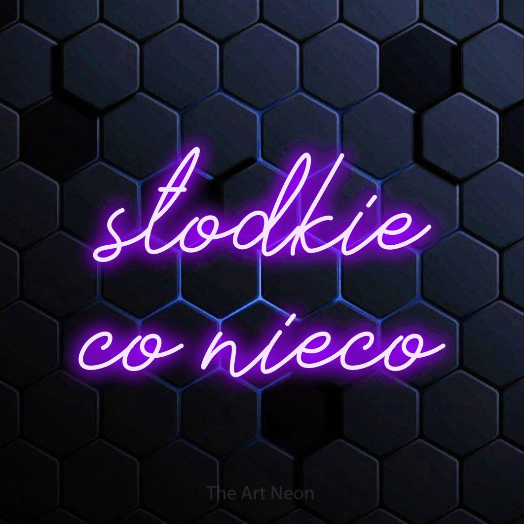 LED neon sign reading “słodkie co nieco”, arranged in two lines.