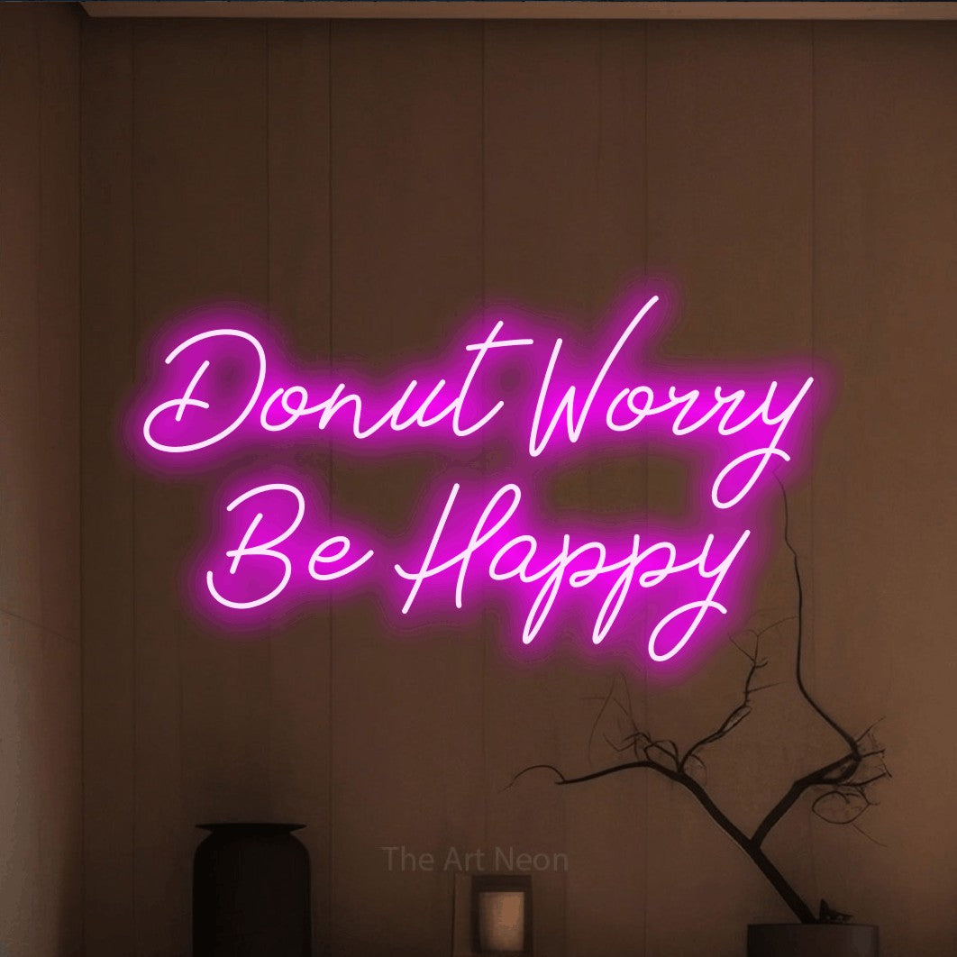 LED neon sign reading “Donut Worry Be Happy”, arranged in two lines.