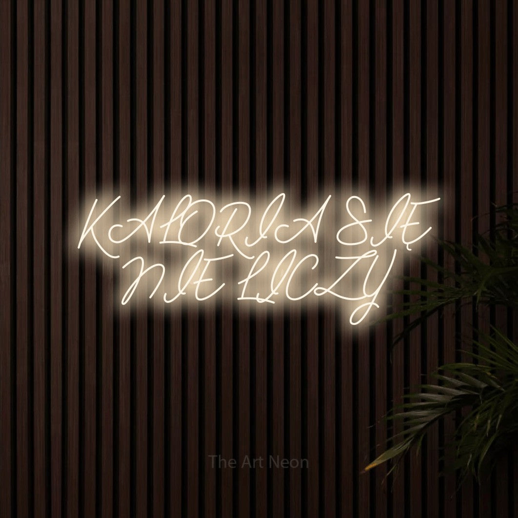 LED neon sign reading “KALORIA SIĘ NIE LICZY”, arranged in two lines.