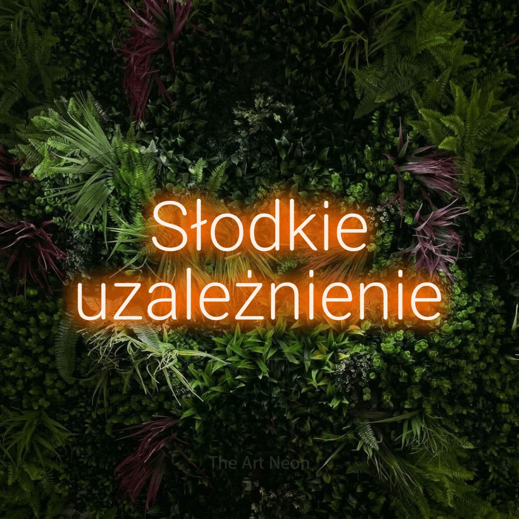 LED neon sign reading “Słodkie uzależnienie”, arranged in two lines.