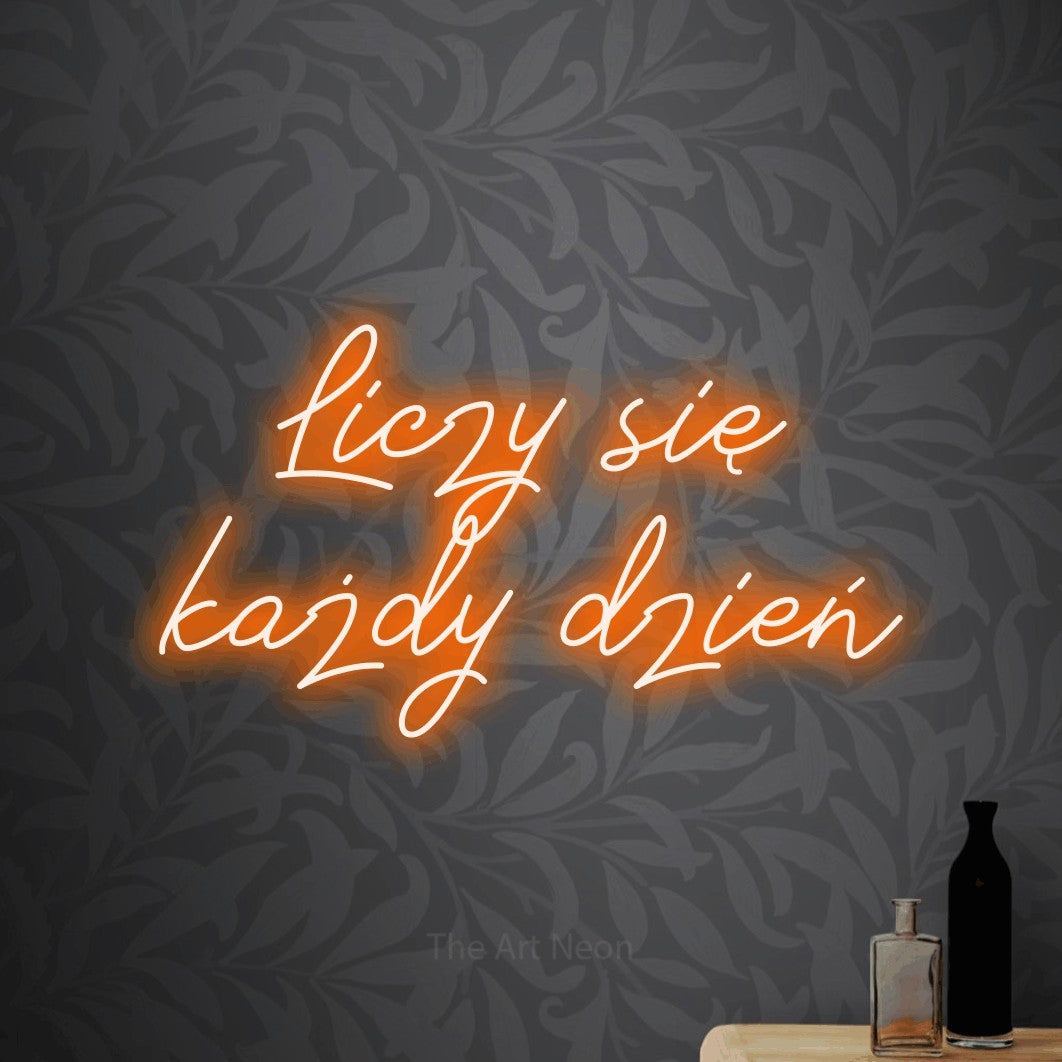 LED neon sign reading “Liczy się każdy dzień”, arranged in two lines.