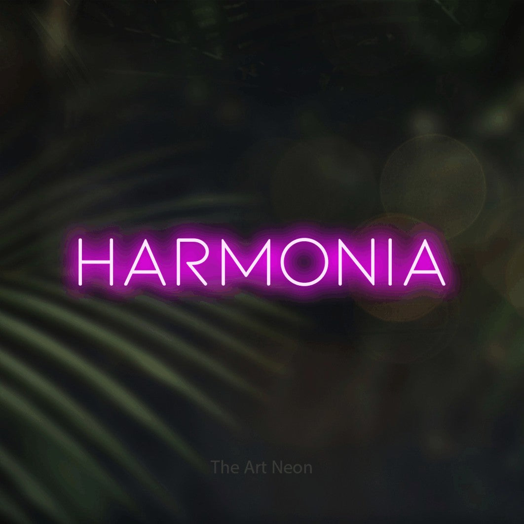 LED neon sign reading “harmonia”, arranged in a single line.