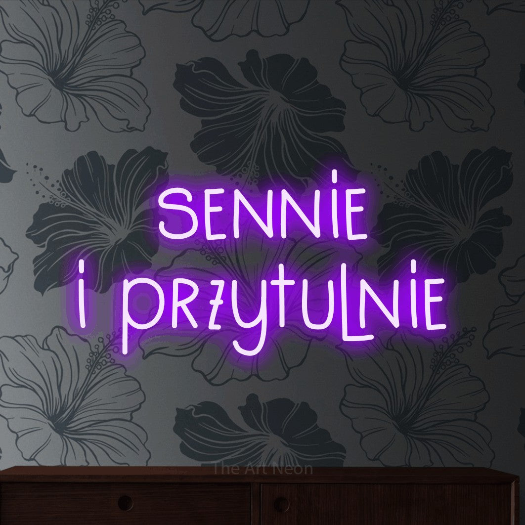 LED neon sign reading “sennie i przytulnie”, arranged in two lines.