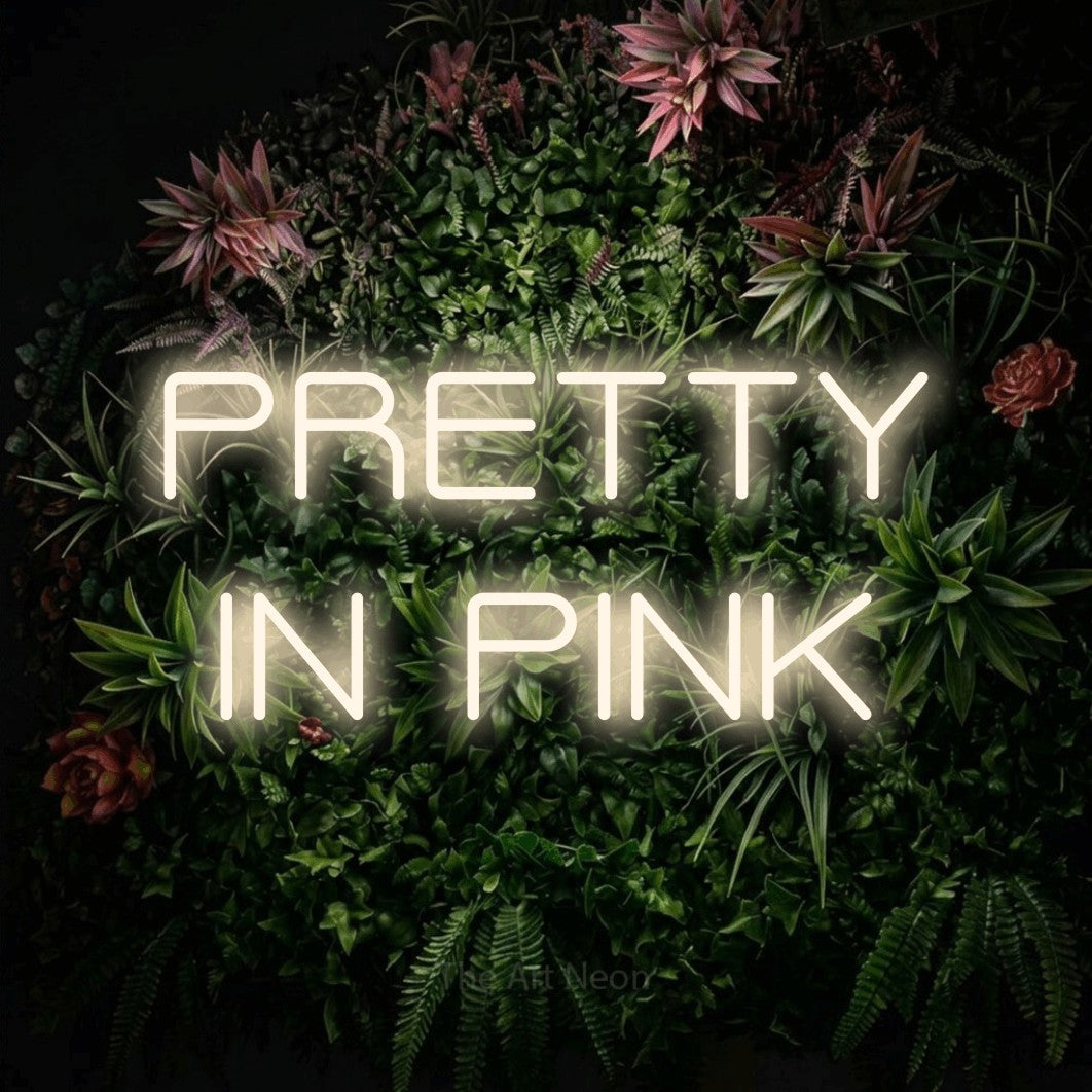 LED neon sign reading “PRETTY IN PINK”, arranged in two lines.