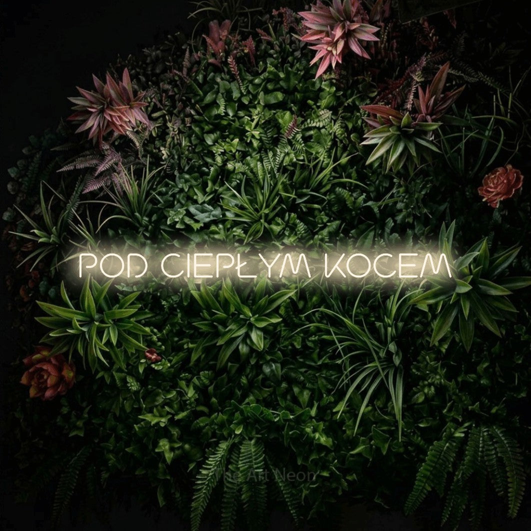 LED neon sign reading “POD CIEPŁYM KOCEM”, arranged in a single line.