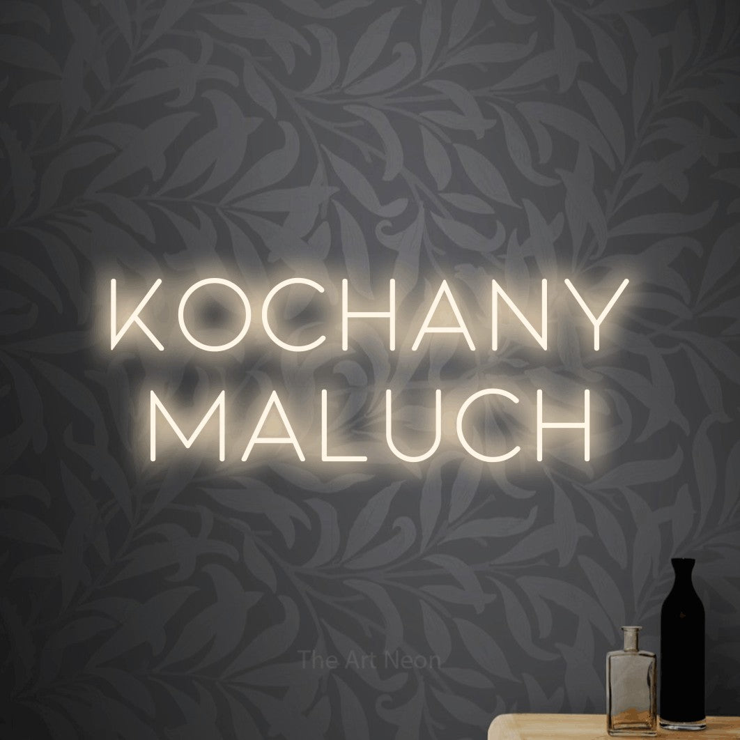 LED neon sign reading “Kochany maluch”, arranged in two lines.