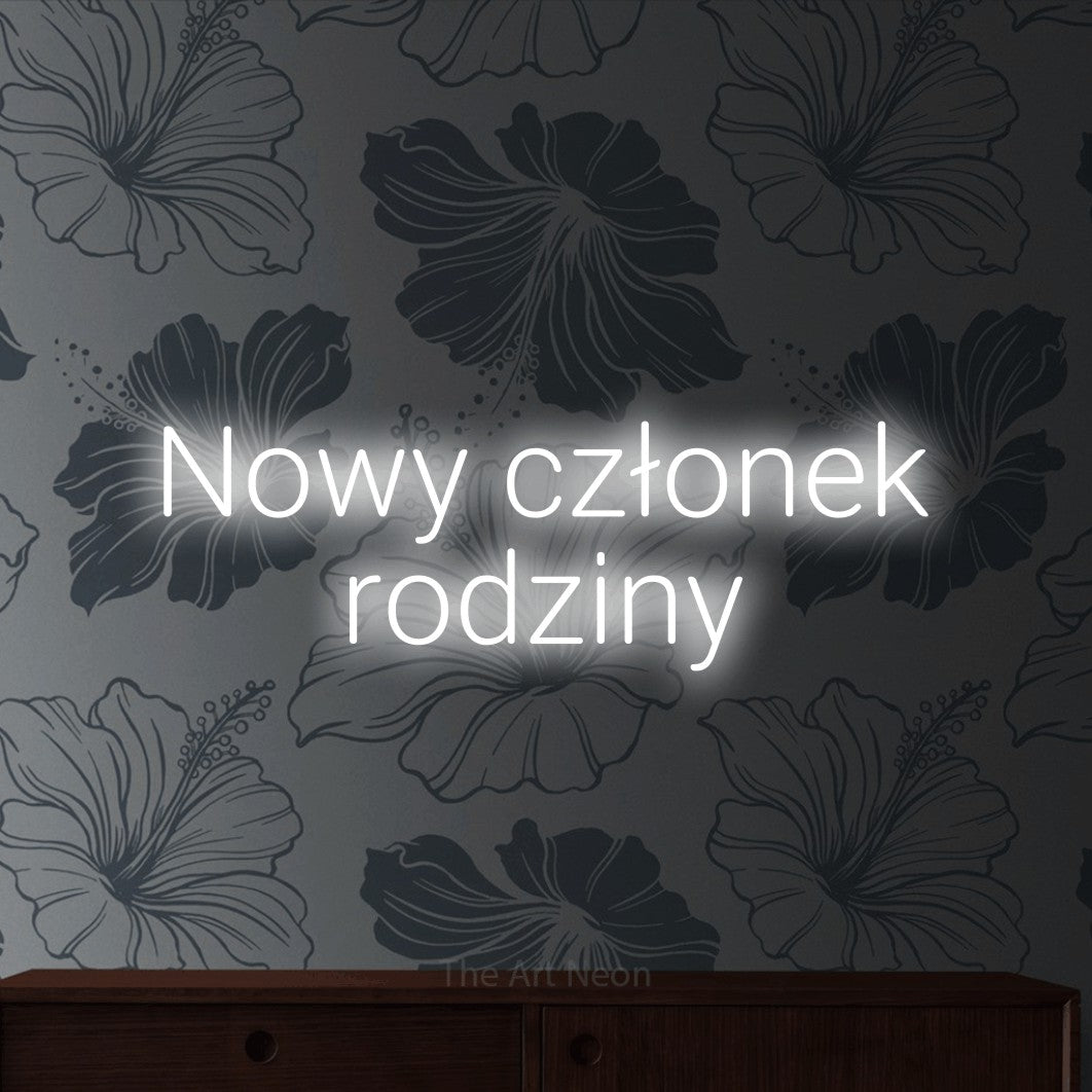 LED neon sign reading “Nowy członek rodziny”, arranged in two lines.