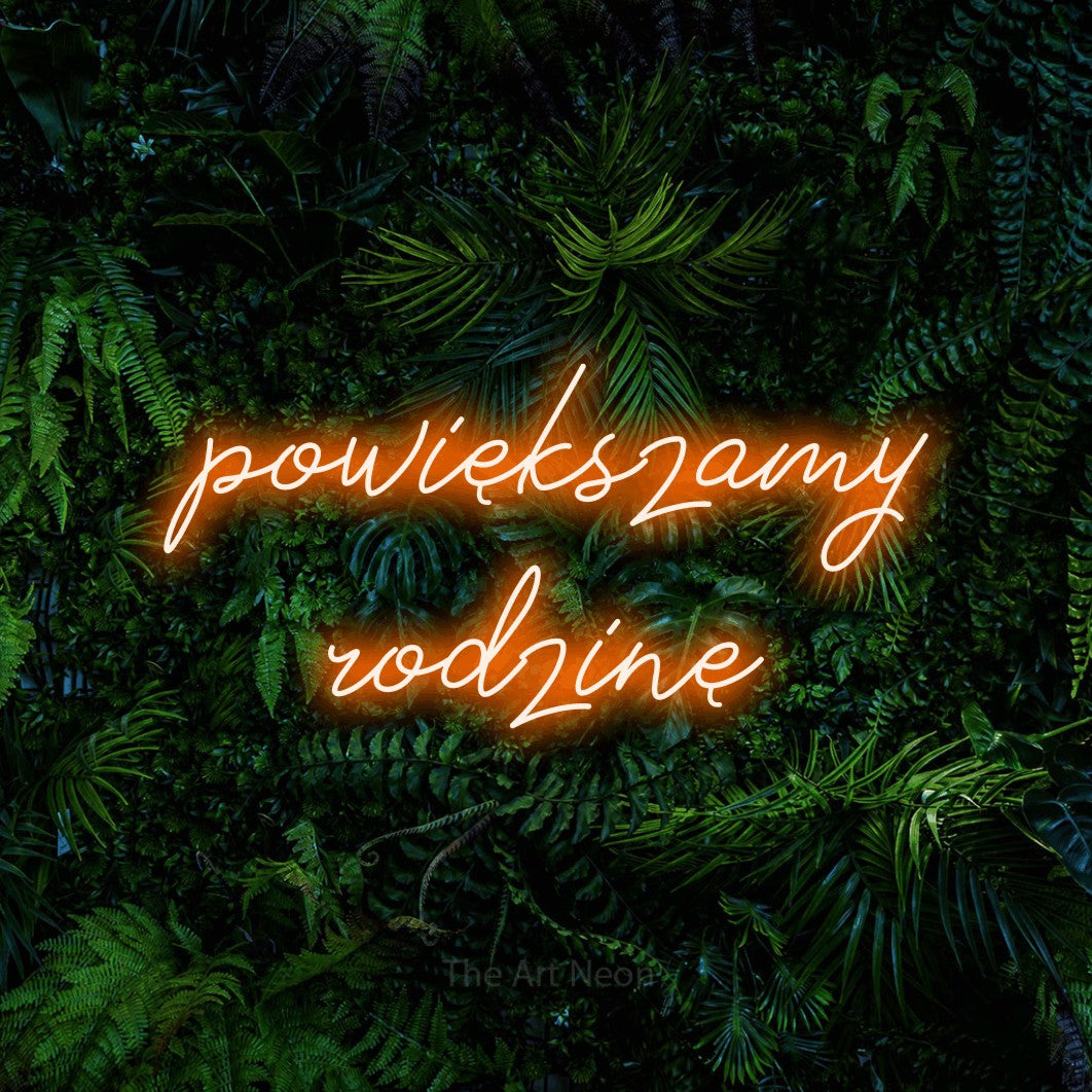 LED neon sign reading “powiększamy rodzinę”, arranged in two lines.