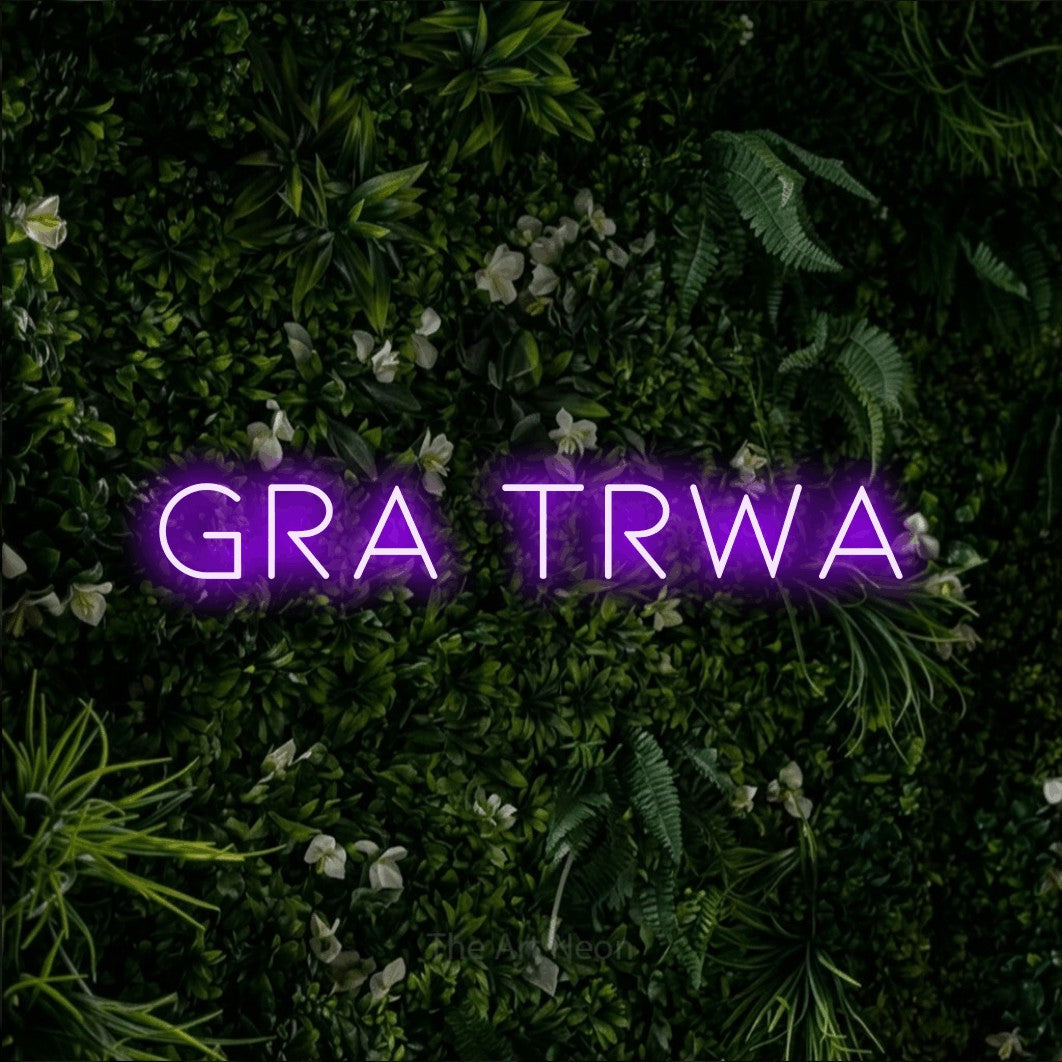 LED neon sign reading “gra TRWA”, arranged in a single line.