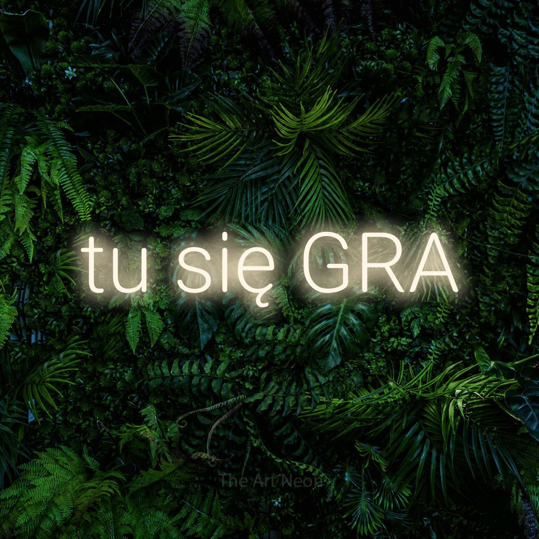 LED neon sign reading “tu się GRA”, arranged in a single line.