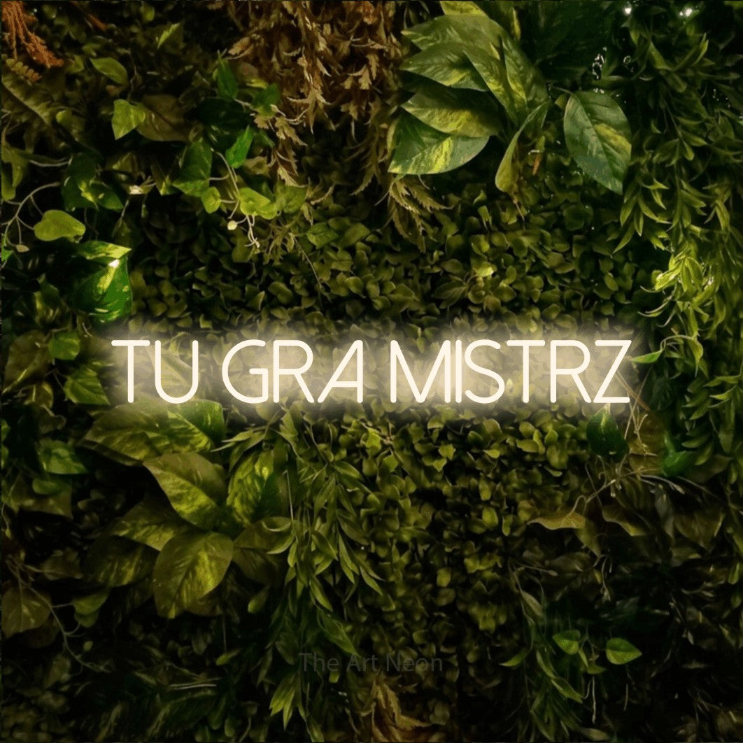 LED neon sign reading “TU GRA MISTRZ”, arranged in a single line.