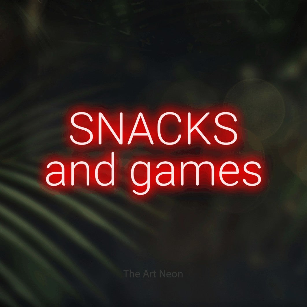 LED neon sign reading “SNACKS and games”, arranged in two lines.