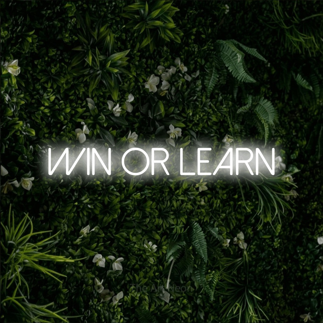 LED neon sign reading “WIN OR LEARN”, arranged in a single line.