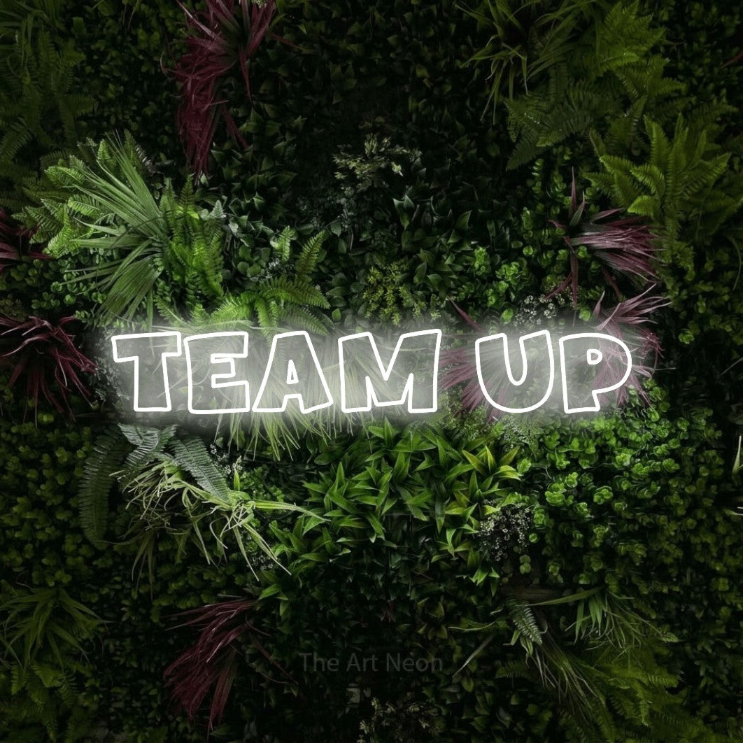 LED neon sign reading “TEAM up”, arranged in a single line.