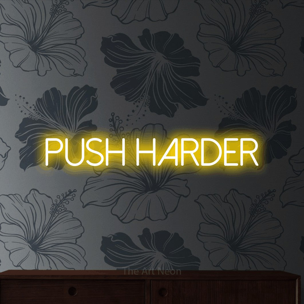 LED neon sign reading “push harder”, arranged in a single line.