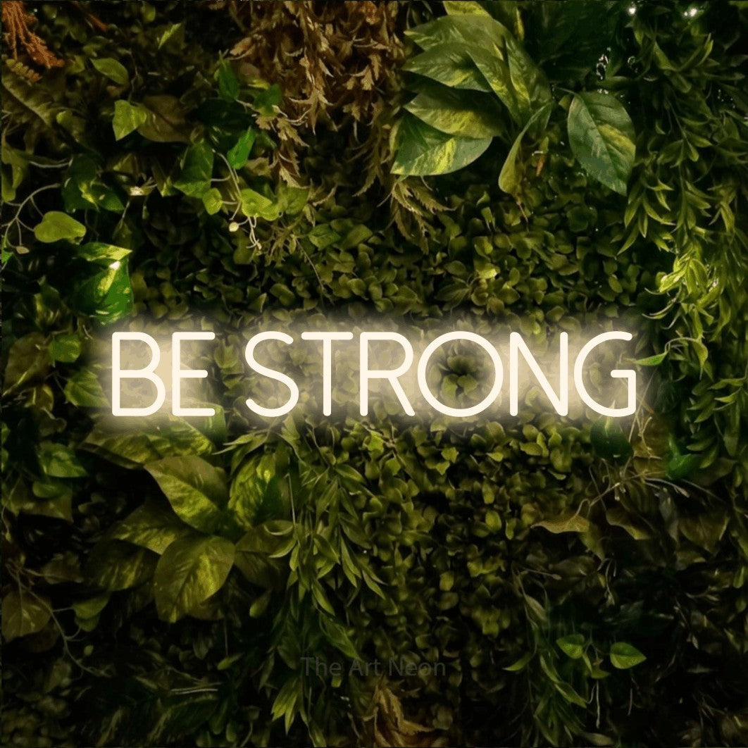 LED neon sign reading “be STRONG”, arranged in a single line.