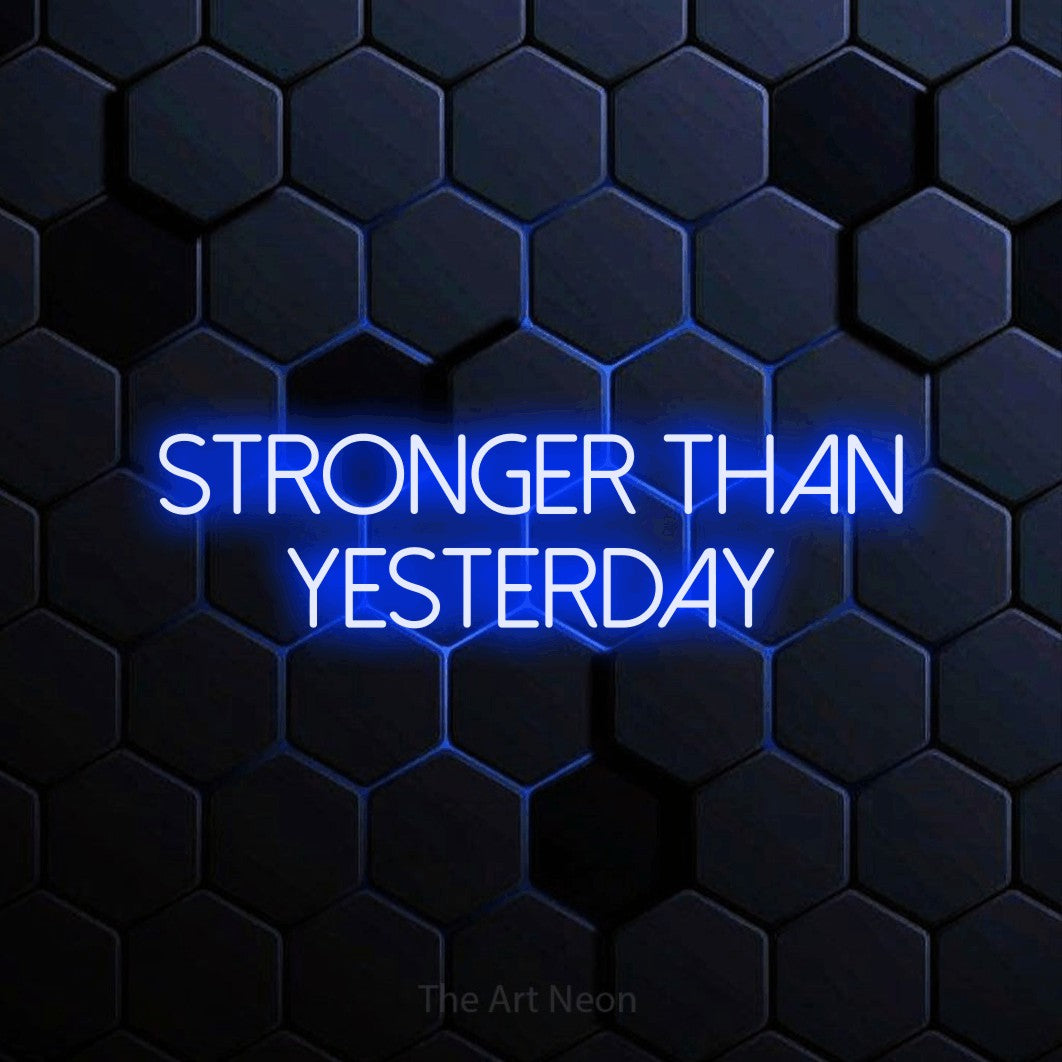 LED neon sign reading “STRONGER THAN YESTERDAY”, arranged in two lines.