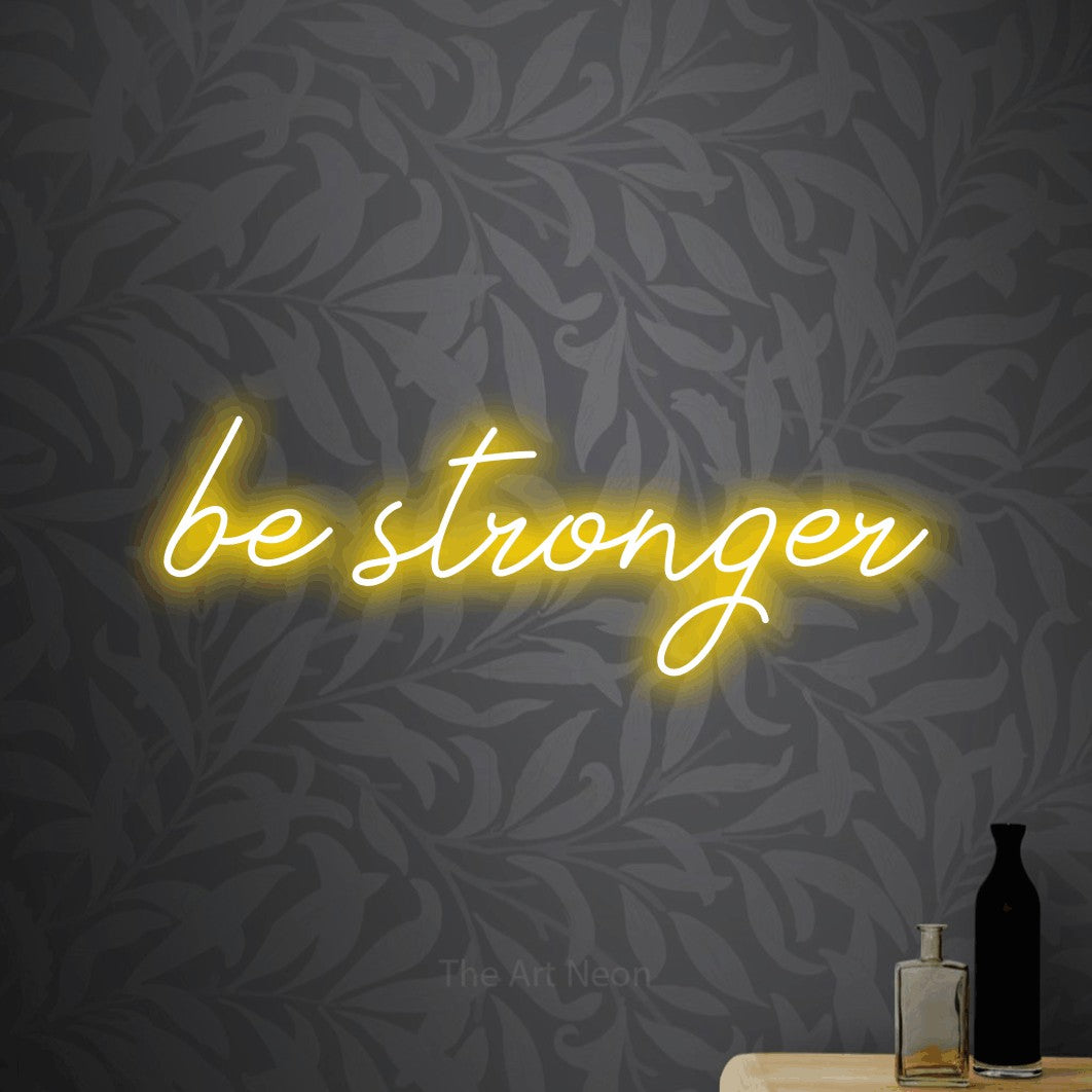 LED neon sign reading “be stronger”, arranged in a single line.