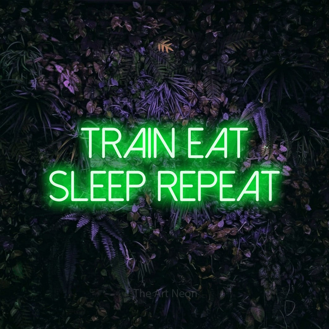 LED neon sign reading “train eat sleep repeat”, arranged in two lines.