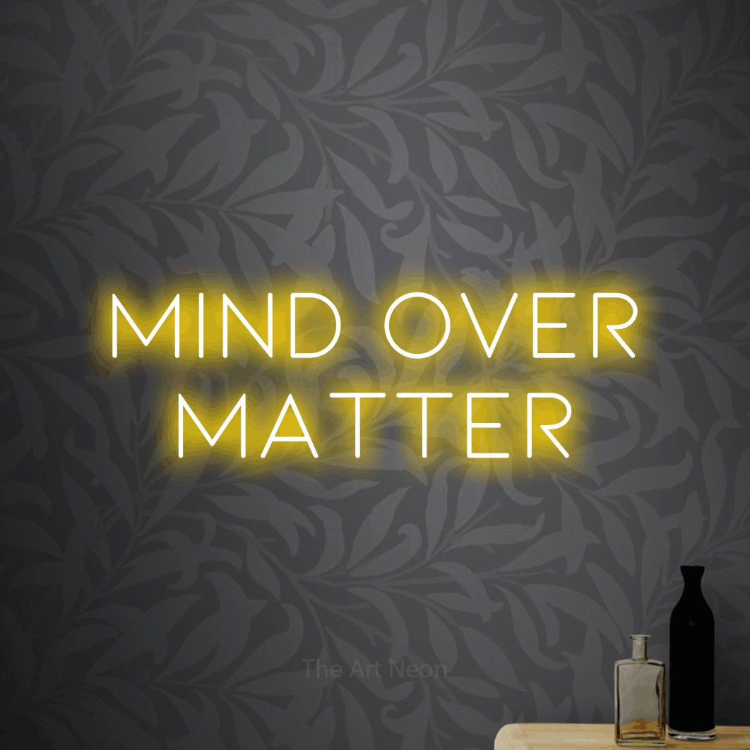 LED neon sign reading “MIND OVER MATTER”, arranged in two lines.
