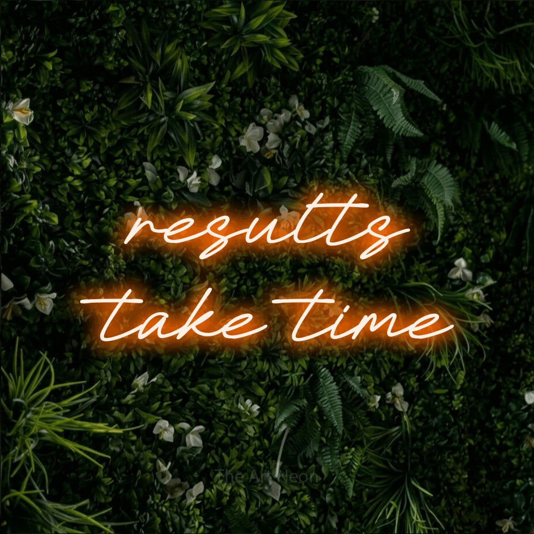 LED neon sign reading “results take time”, arranged in two lines.