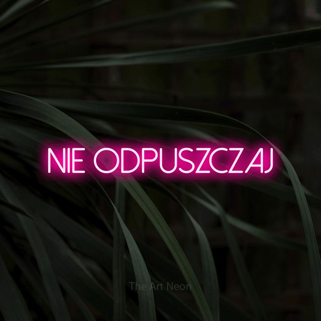 LED neon sign reading “nie odpuszczaj”, arranged in a single line.