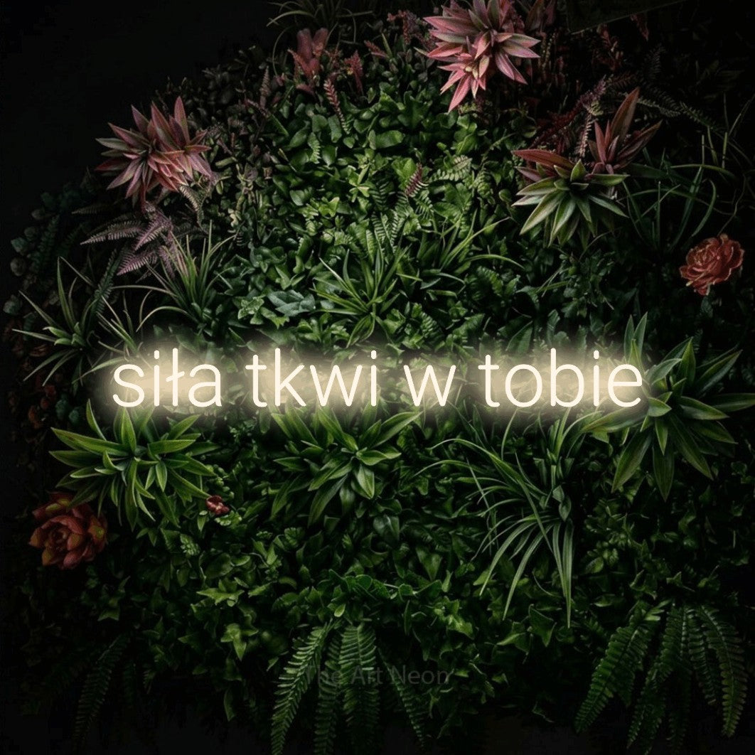 LED neon sign reading “siła tkwi w tobie”, arranged in a single line.