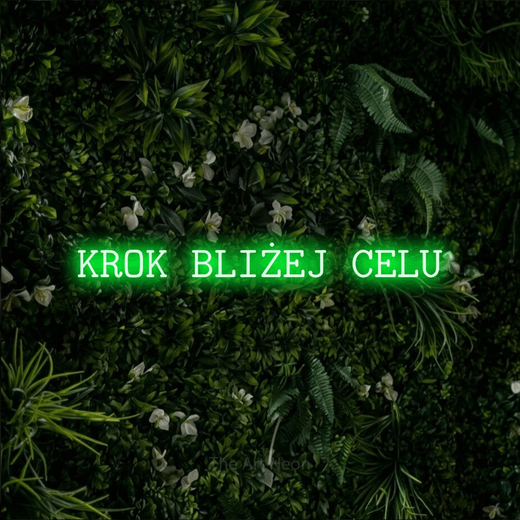 LED neon sign reading “KROK BLIŻEJ CELU”, arranged in a single line.