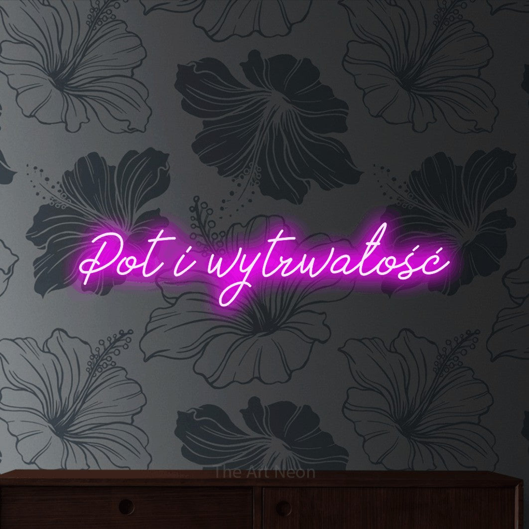 LED neon sign reading “Pot i wytrwałość”, arranged in a single line.