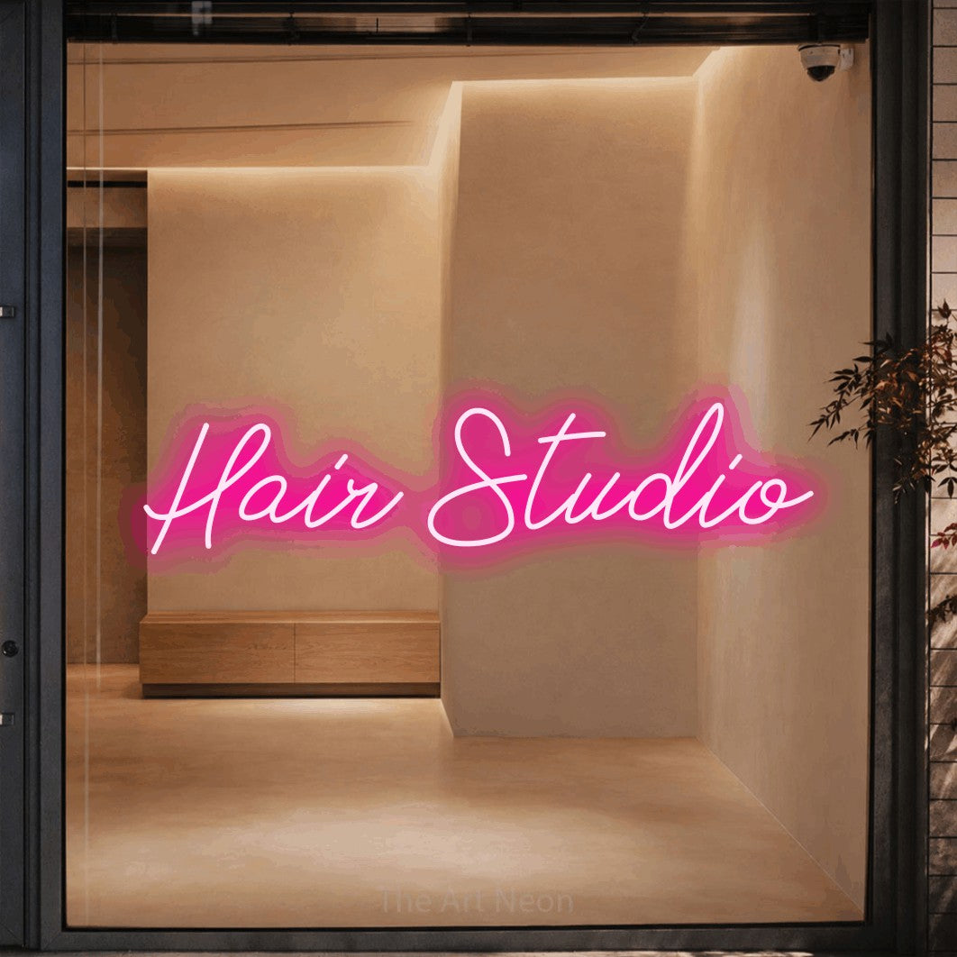 LED neon sign reading “Hair Studio”, arranged in a single line.