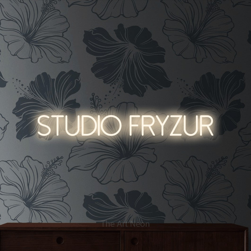 LED neon sign reading “STUDIO fryzur”, arranged in a single line.