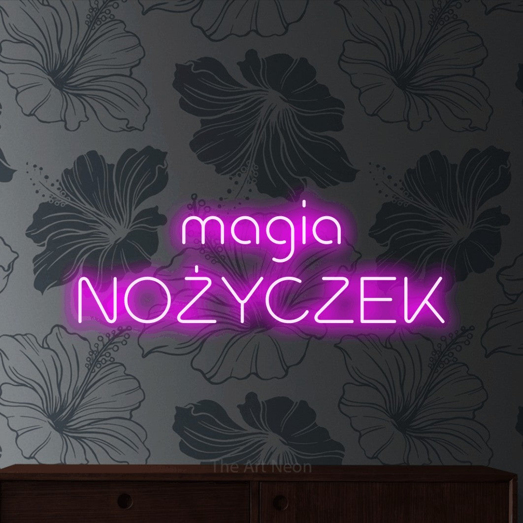 LED neon sign reading “magia NOŻYCZEK”, arranged in two lines.