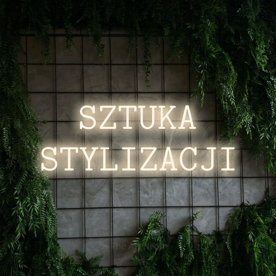 LED neon sign reading “SZTUKA STYLIZACJI”, arranged in two lines.