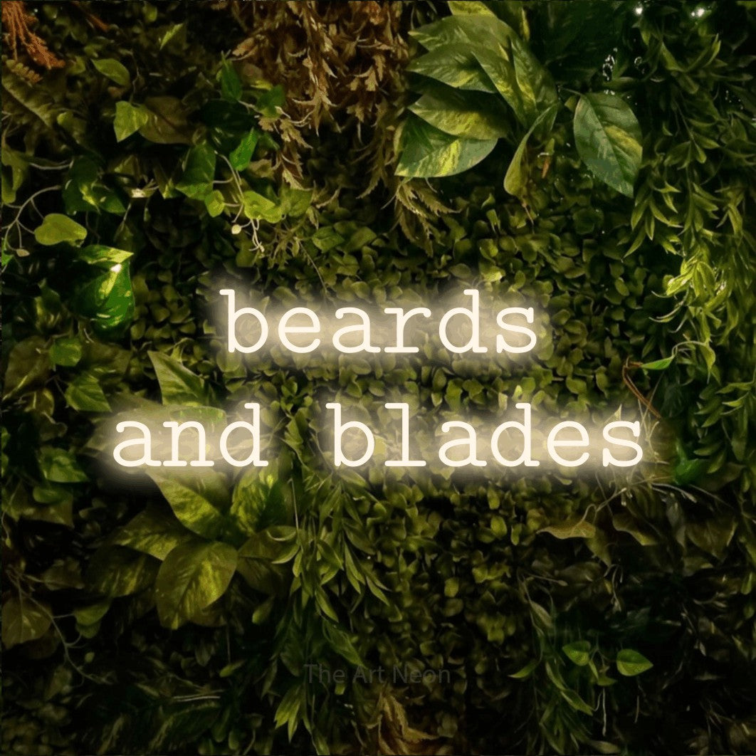 LED neon sign reading “beards and blades”, arranged in two lines.