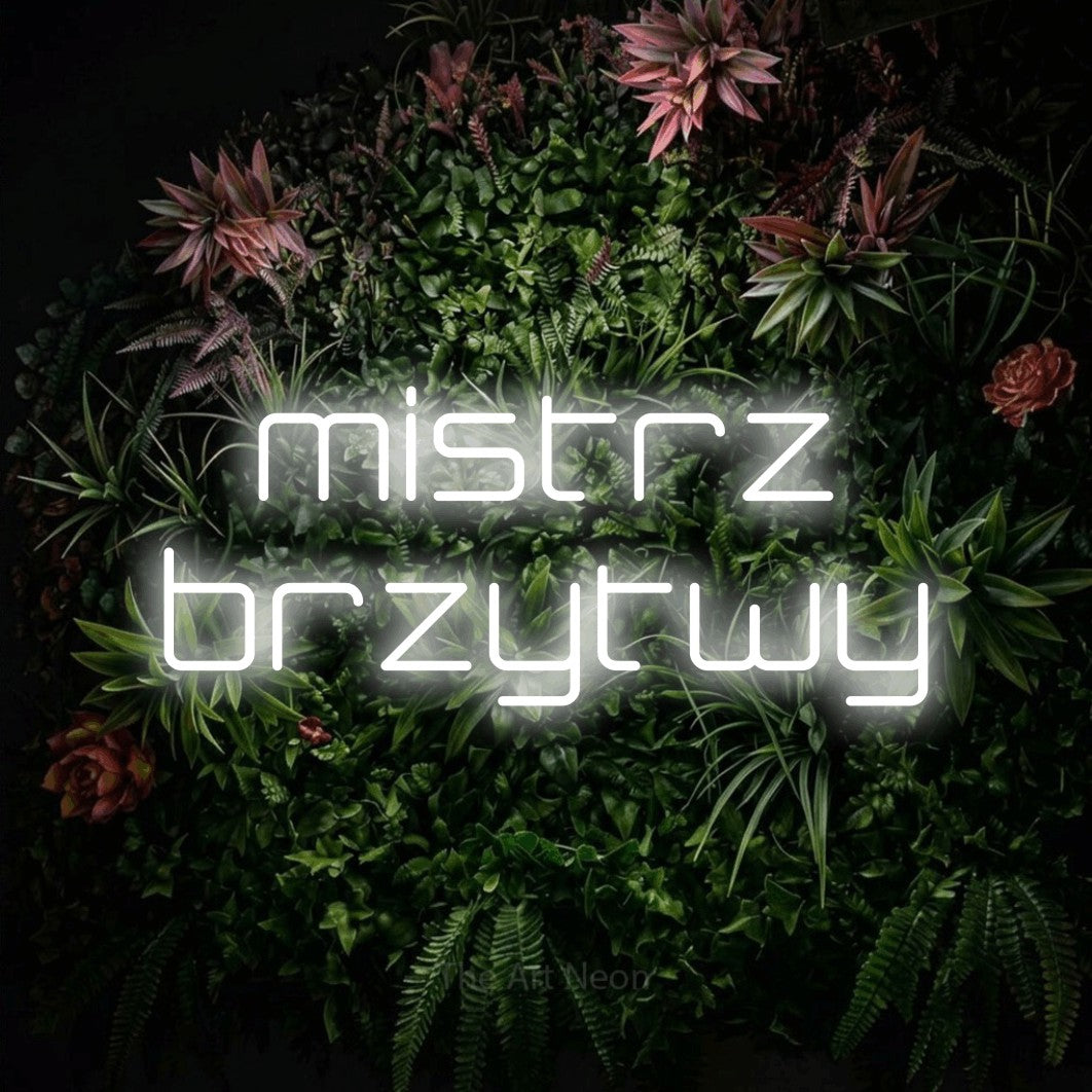 LED neon sign reading “mistrz brzytwy”, arranged in two lines.