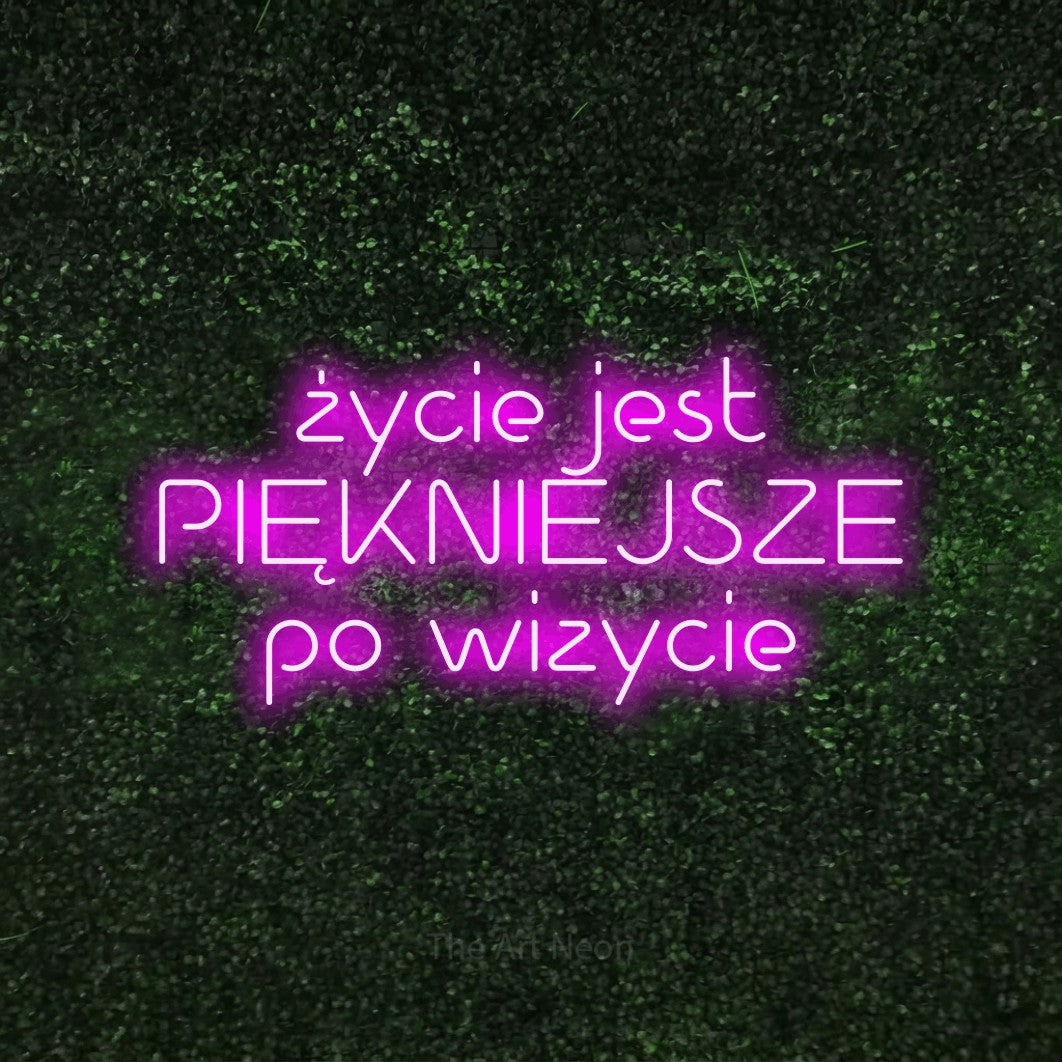 LED neon sign reading “życie jest PIĘKNIEJSZE po wizycie”, arranged in three lines.