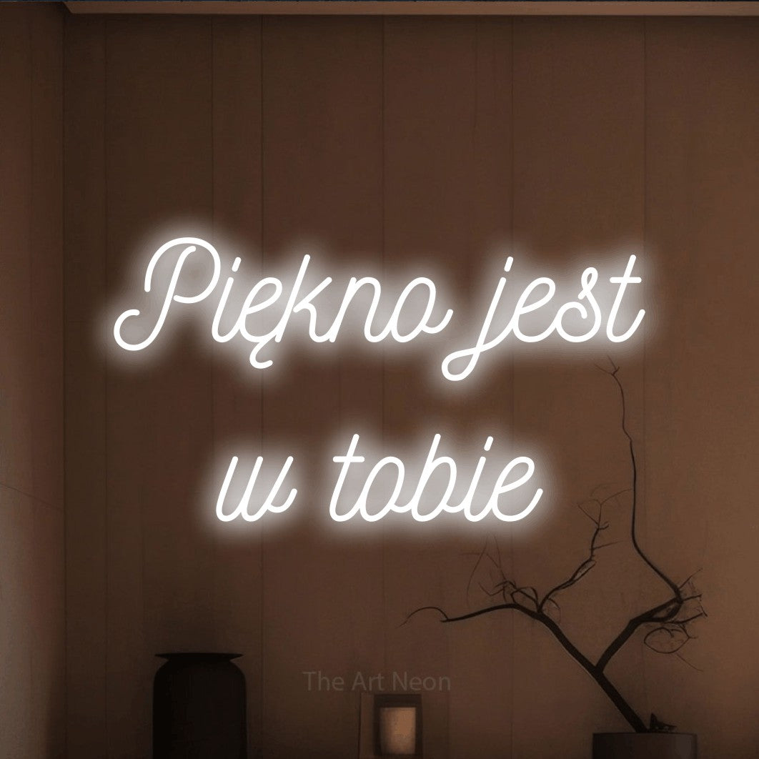 LED neon sign reading “Piękno jest w tobie”, arranged in two lines.