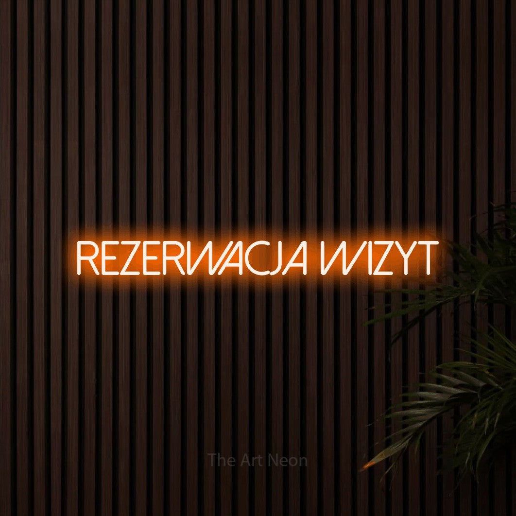 LED neon sign reading “REZERWACJA wizyt”, arranged in a single line.