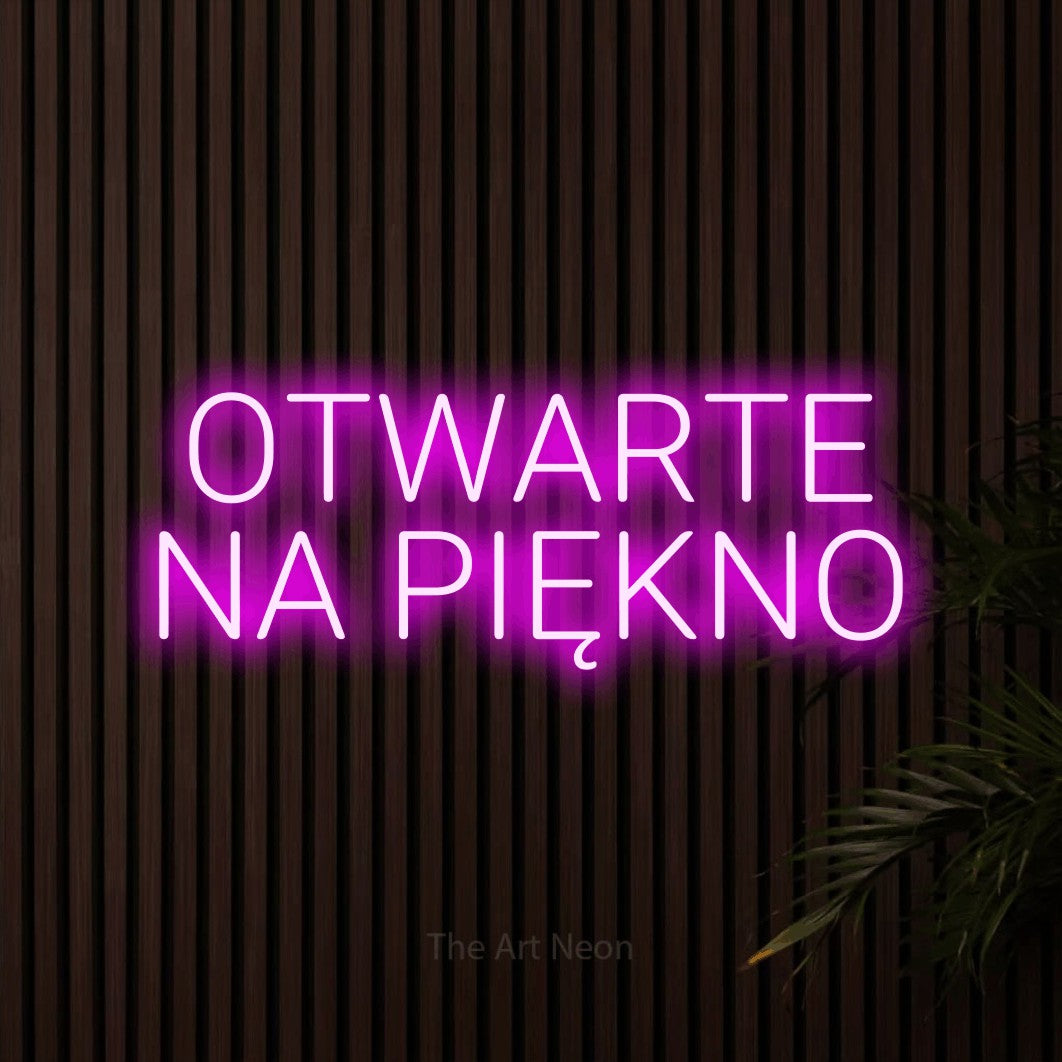 LED neon sign reading “OTWARTE NA PIĘKNO”, arranged in two lines.