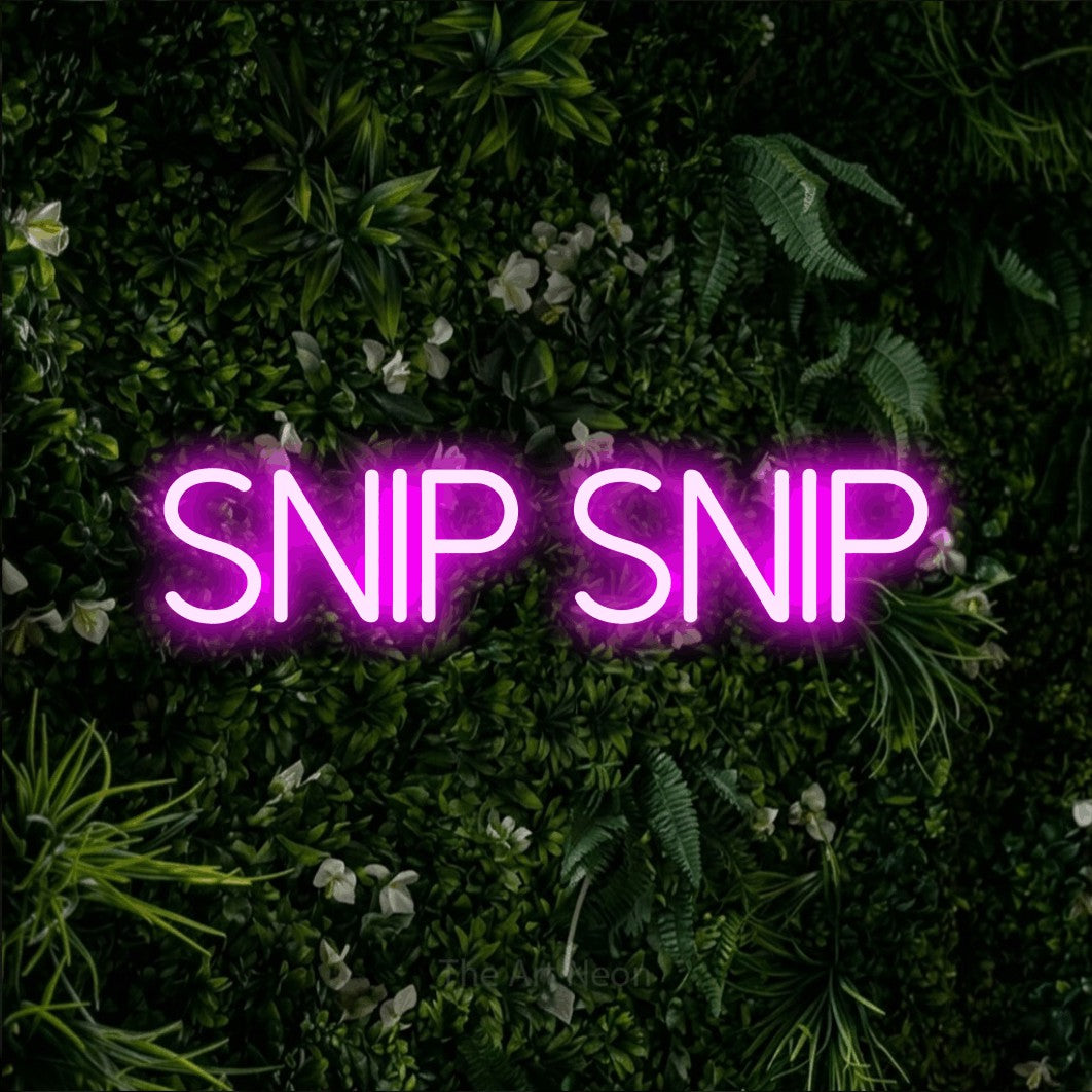 LED neon sign reading “Snip Snip”, arranged in a single line.