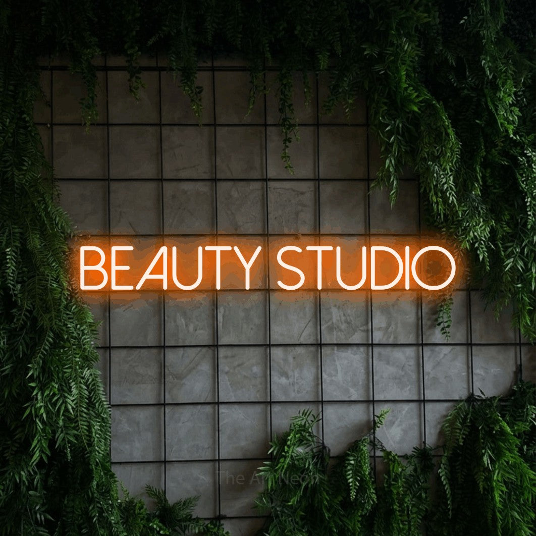 LED neon sign reading “BEAUTY studio”, arranged in a single line.