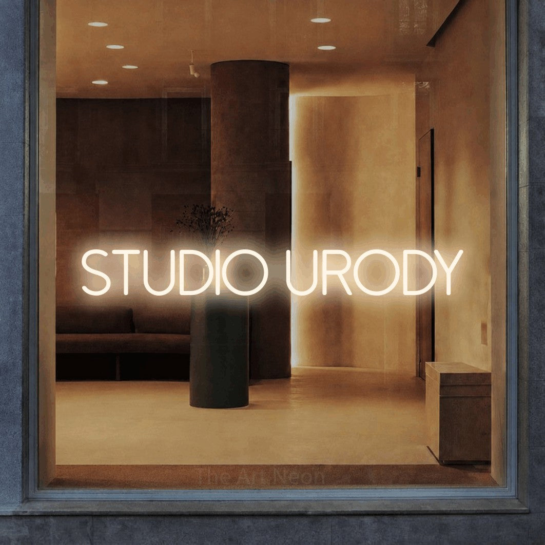 LED neon sign reading “STUDIO URODY”, arranged in a single line.