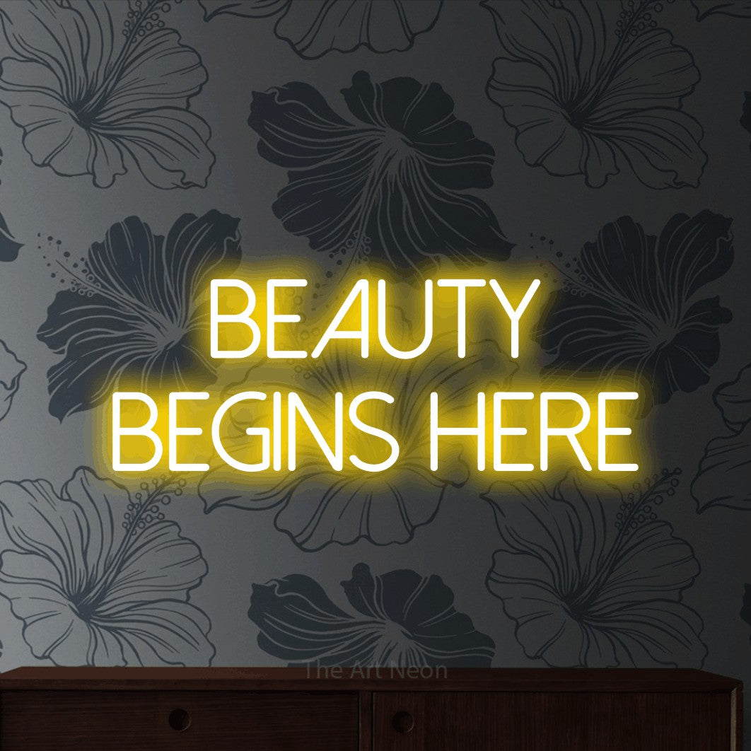 LED neon sign reading “Beauty Begins Here”, arranged in two lines.