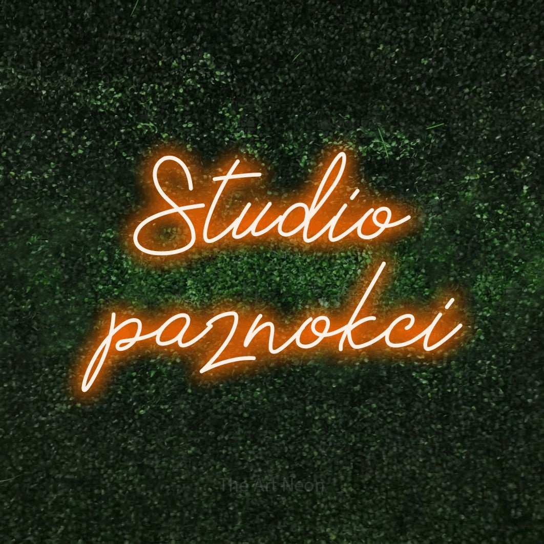 LED neon sign reading “Studio paznokci”, arranged in two lines.