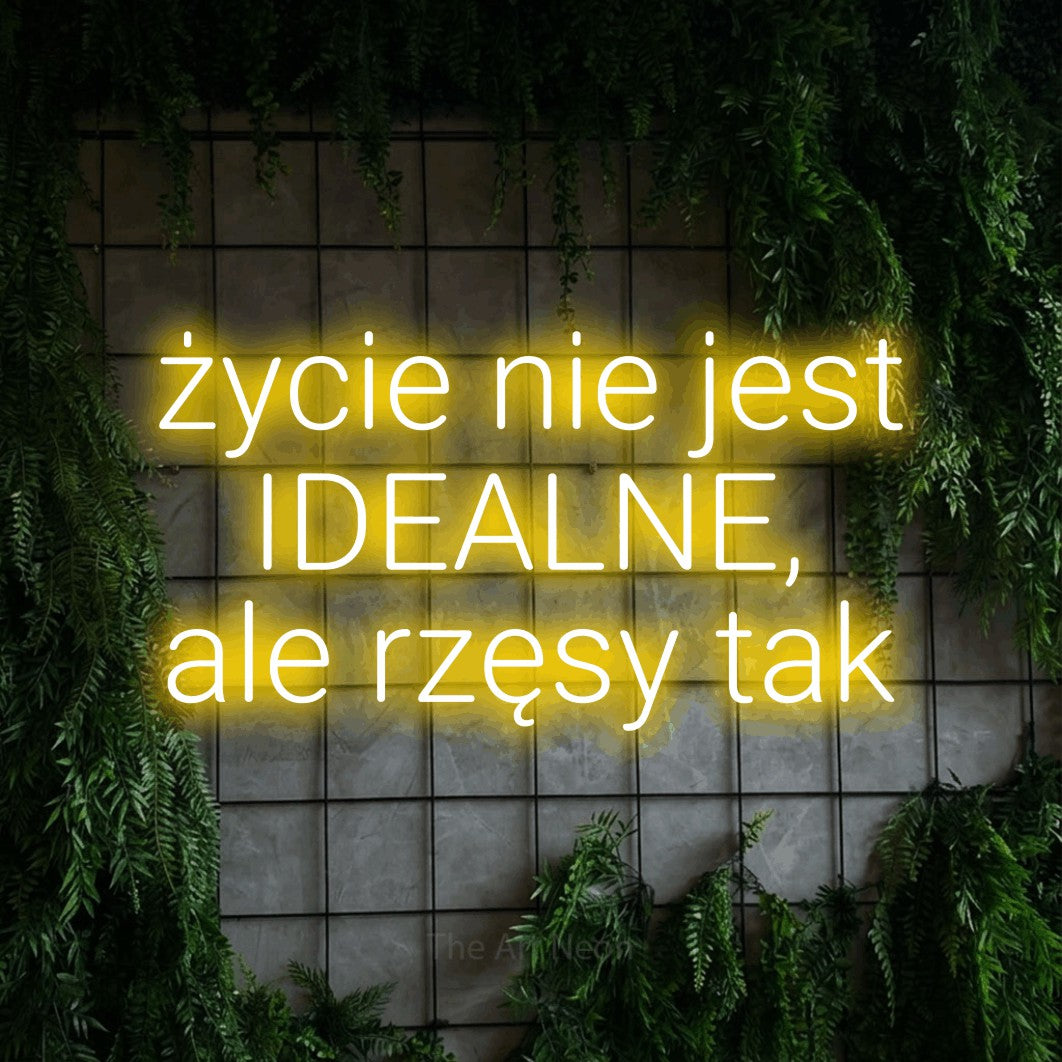 LED neon sign reading “życie nie jest IDEALNE, ale rzęsy tak”, arranged in three lines.