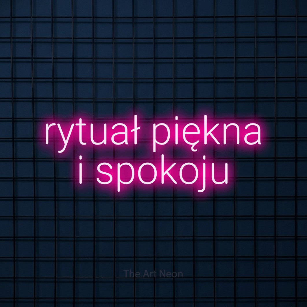 LED neon sign reading “rytuał piękna i spokoju”, arranged in two lines.