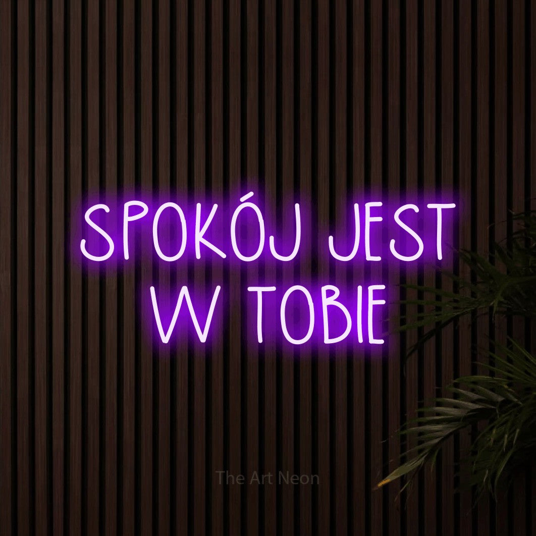 LED neon sign reading “SPOKÓJ JEST W TOBIE”, arranged in two lines.
